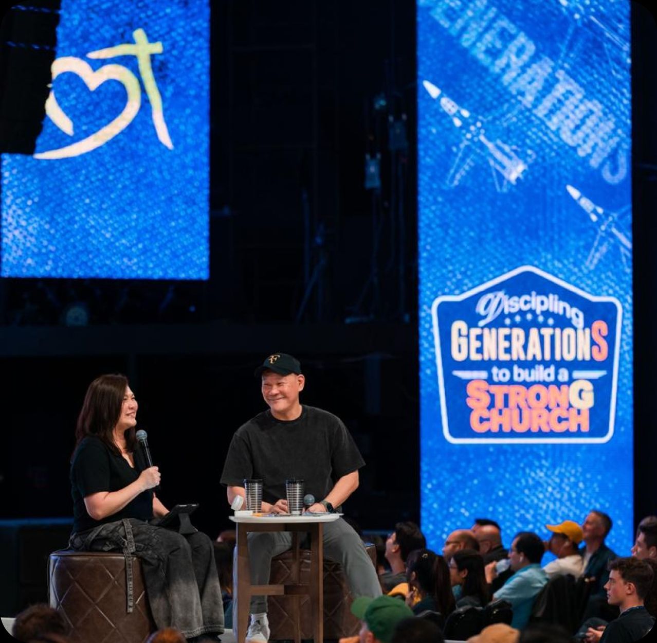 Pastor How and Pastor Lia, co-founders and co-senior pastors of Heart of God Church Singapore, teaching together on stage